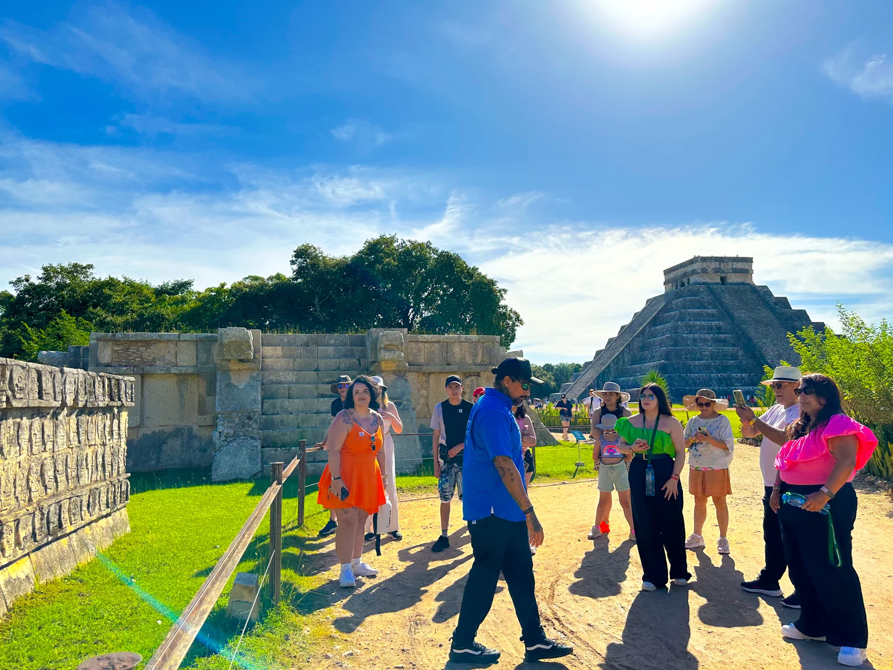 Grupo visitante recorre un sitio arqueológico maya en una excursión de Amigo Tours
