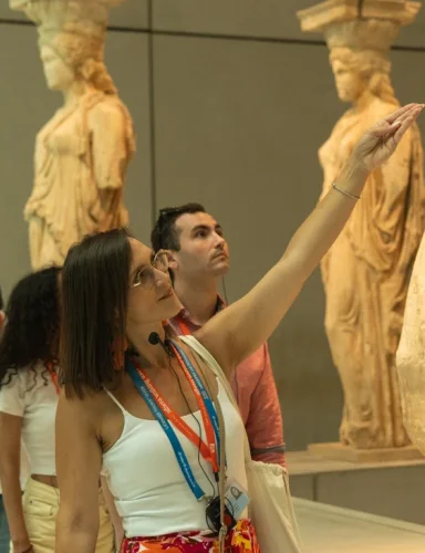 Visitantes observan esculturas en un tour cultural privado de Athens Walking Tours