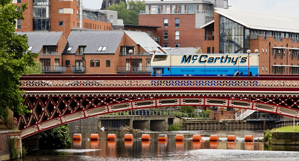 McCarthy’s branded removal truck crossing a bridge in Leeds
