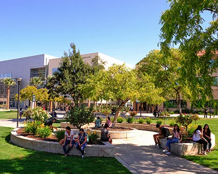 Estudiantes en el patio central arbolado del campus de Moreno Valley College.
