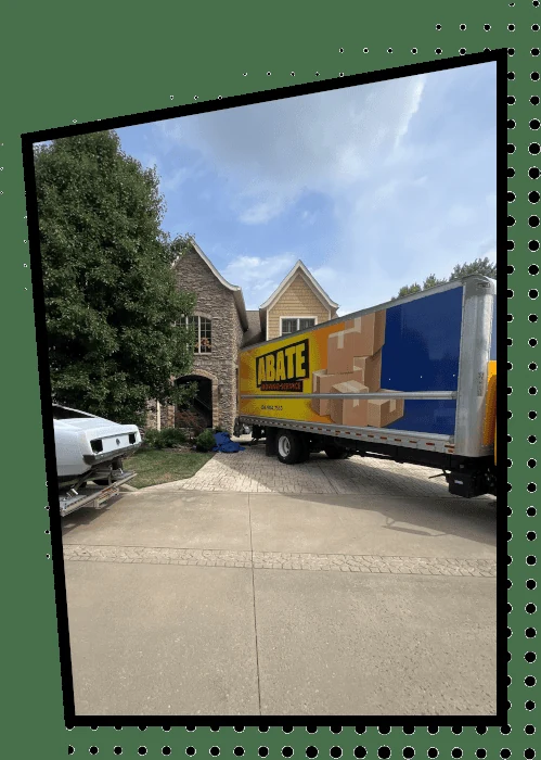 Abate Moving truck outside a suburban home, official company photo.