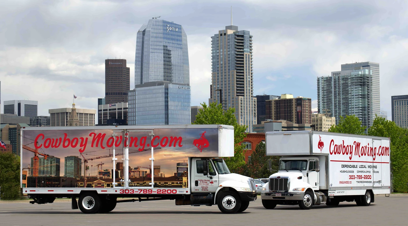 Cowboy Moving & Storage branded moving trucks in Denver | Camiones rotulados de Cowboy Moving & Storage en Denver