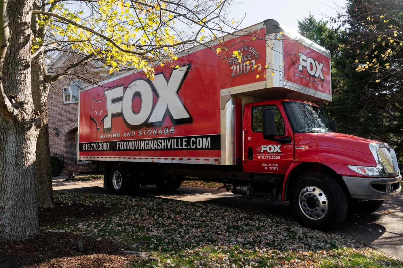 Fox Moving & Storage branded truck at a home in Knoxville, from the official website.