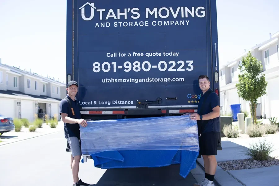 Utah’s Moving & Storage crew with wrapped furniture, image from its official website.