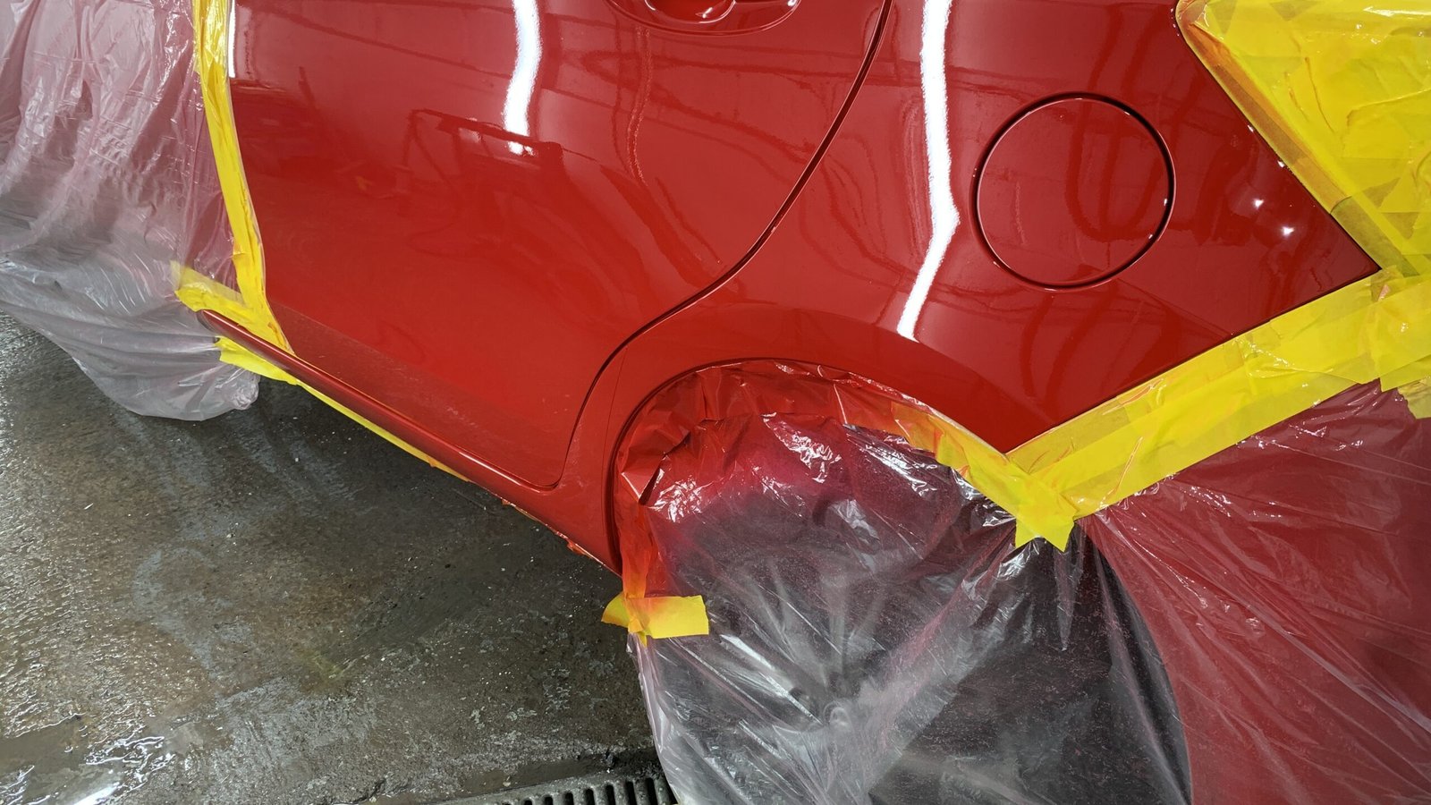 Red vehicle panel masked for paintwork at Matthew’s Garage