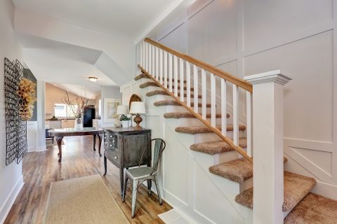 Living-room furniture display beside a staircase in the showroom.