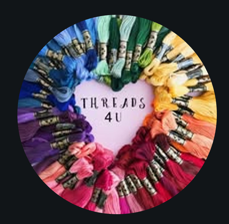 A circular display of colorful embroidery threads arranged by color.
