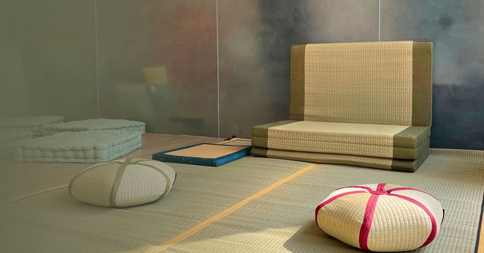 Tatami floor seating with cushions and a low table.