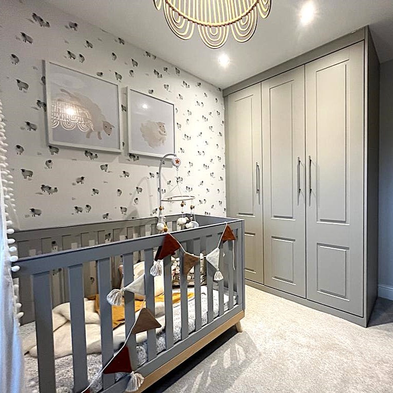 Built-in bedroom wardrobe with hinged doors by The Gooding Group.