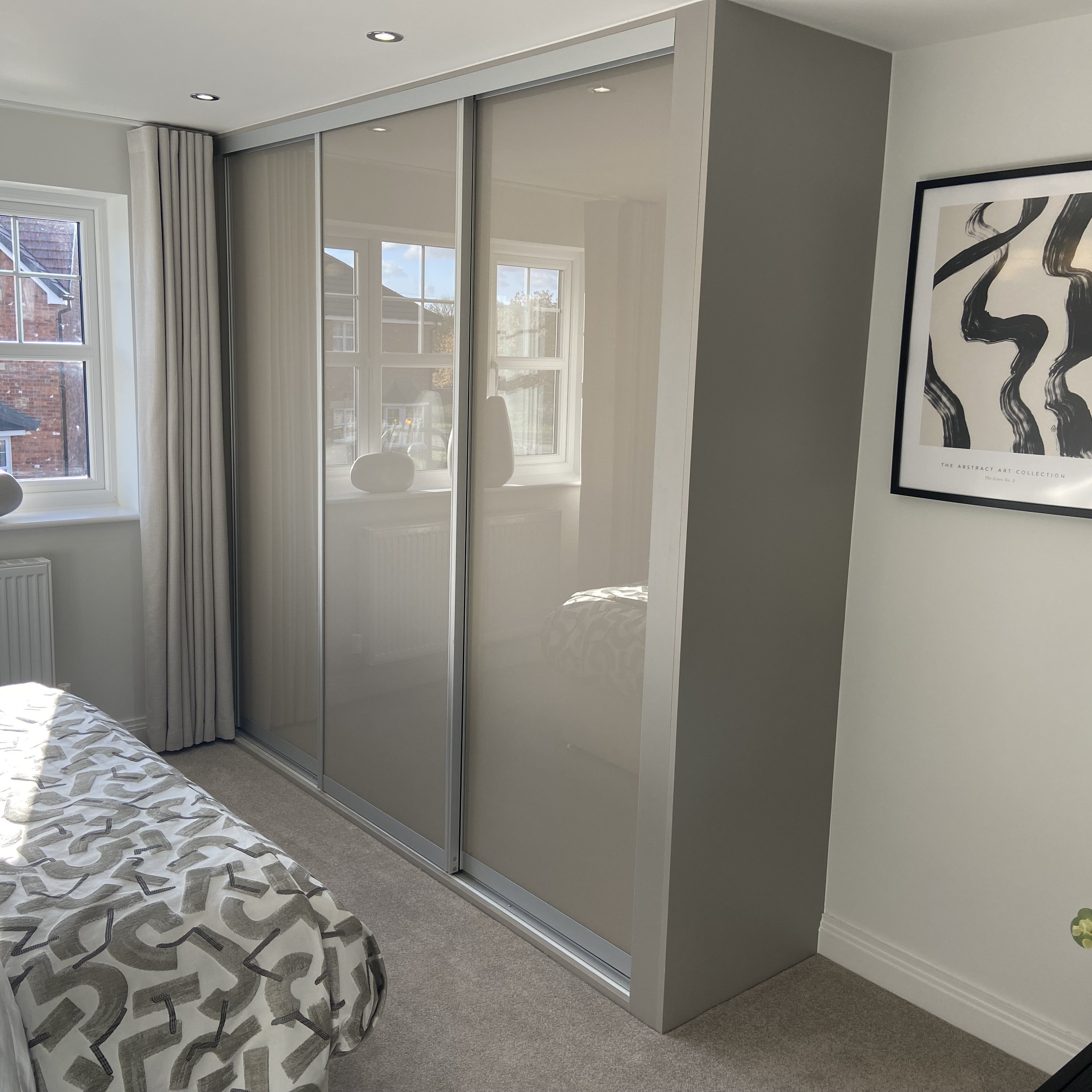 Fitted white wardrobe installed in a bedroom by The Gooding Group.