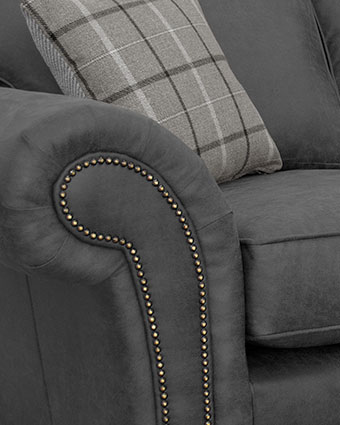 Gray fabric sofa with button-tufted upholstery.