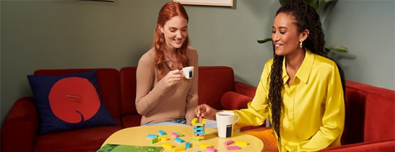 Two people sharing coffee at a table.
