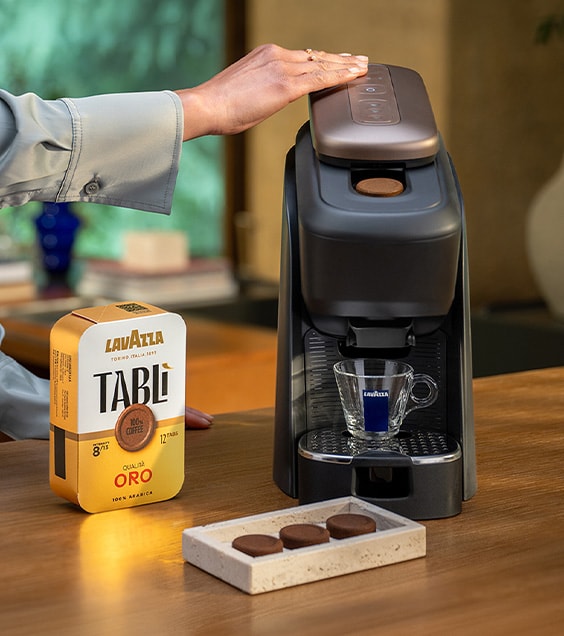 Lavazza coffee machine and coffee product displayed on a counter.