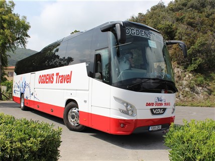 David Ogden Holidays coach on a rural road.