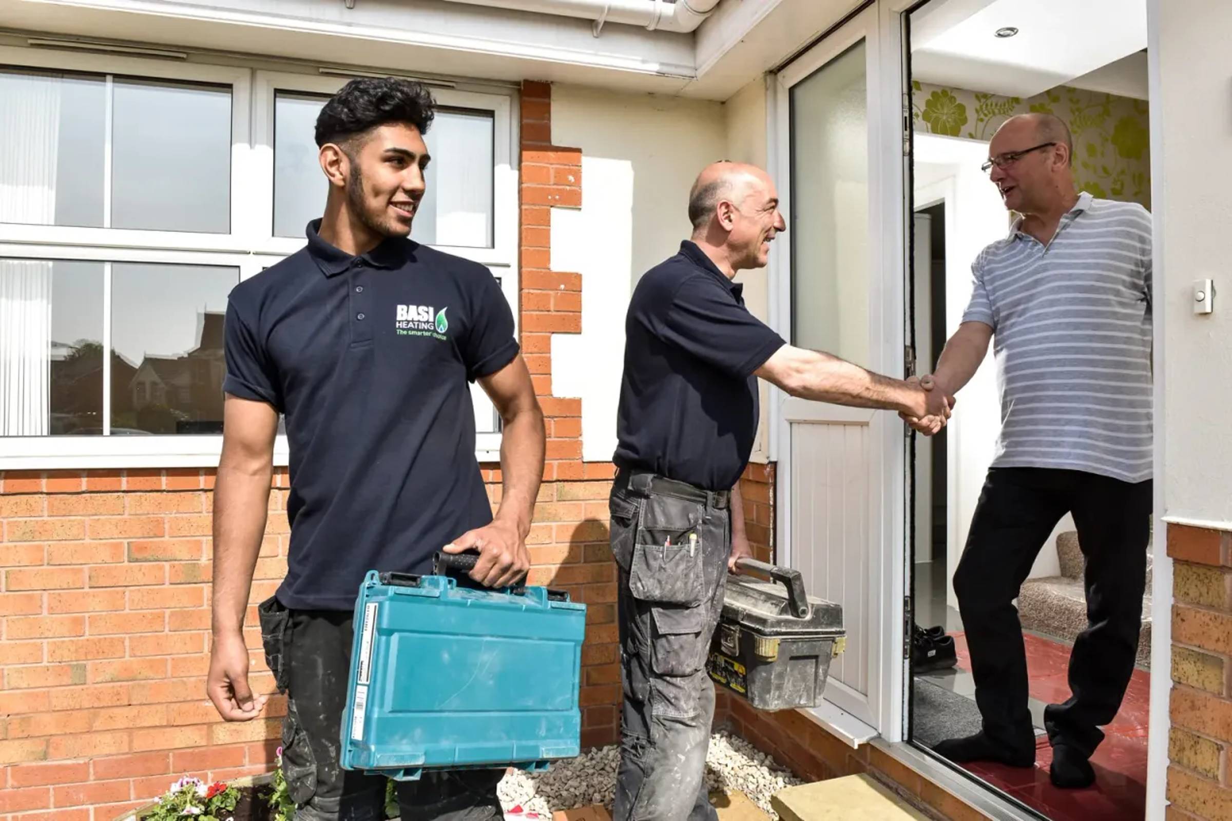 Heating engineer meeting with a customer in a home.