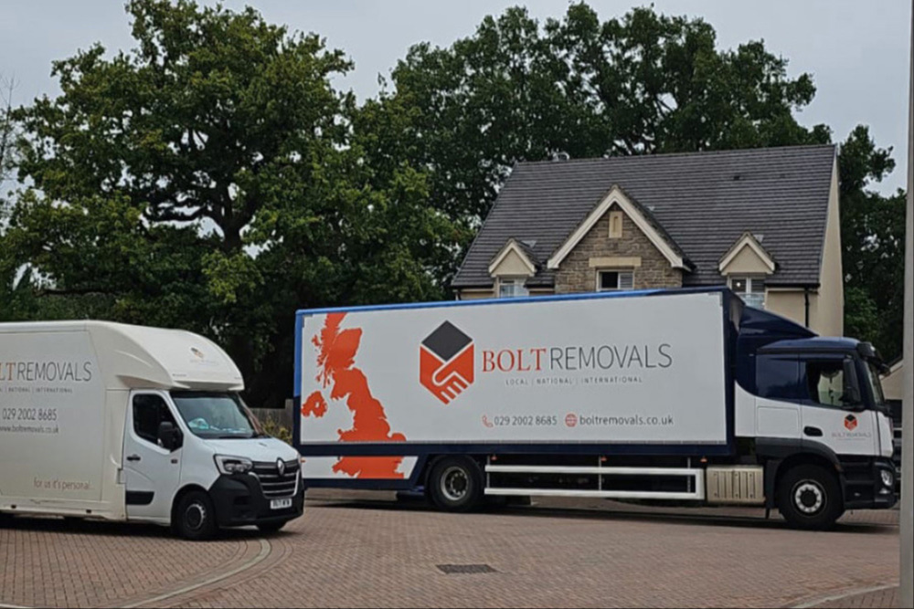 Bolt Removals moving trucks parked outside a home.