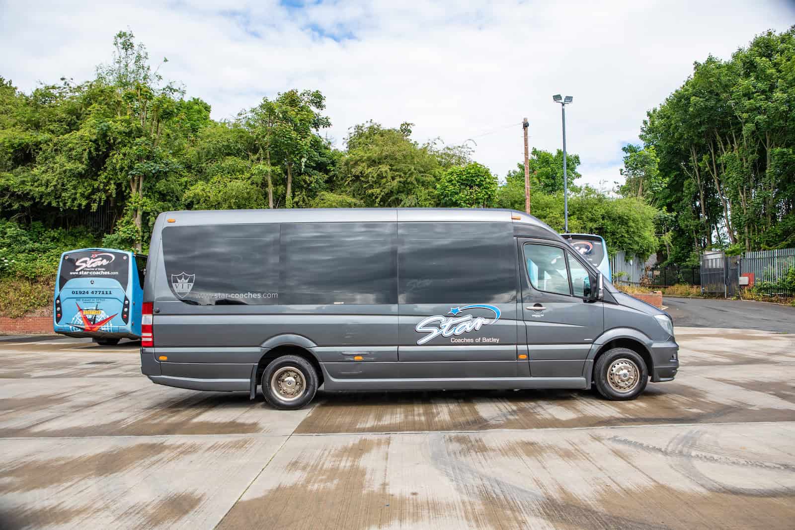 A Star Coaches minibus parked beside the depot.