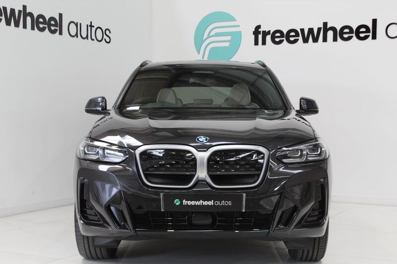 A used BMW displayed in the Freewheel Autos showroom.
