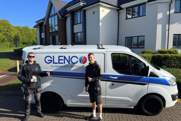Two Glenco workers standing beside a branded plumbing service van.