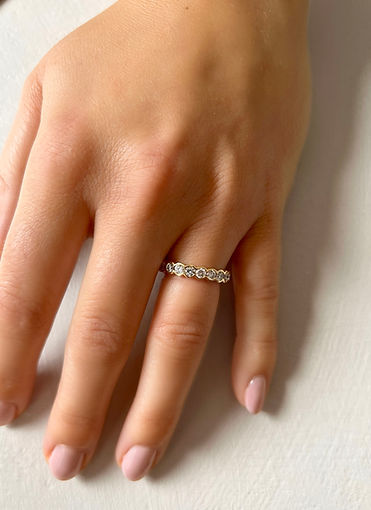 A hand wearing a diamond ring
