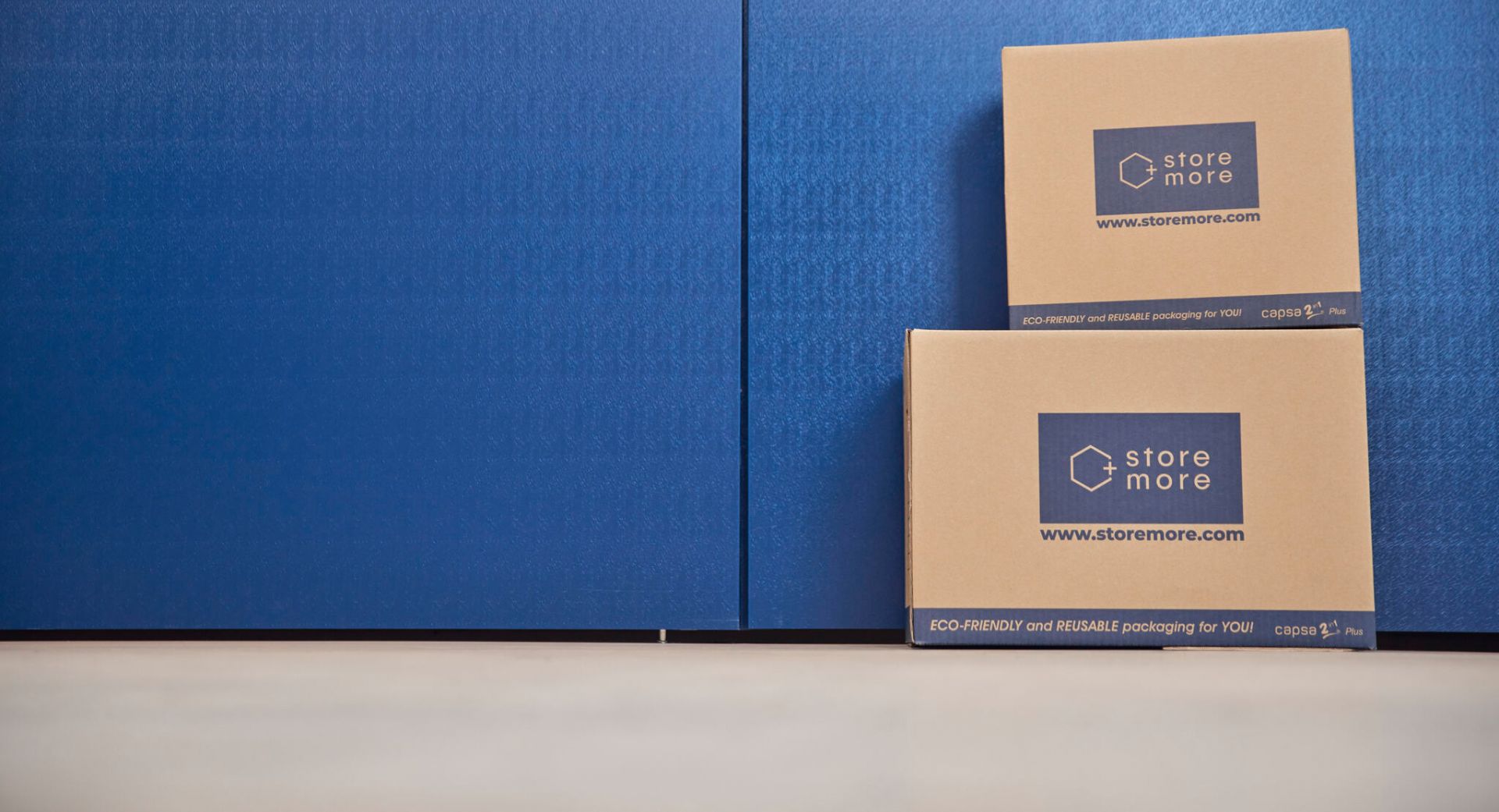 Cardboard storage boxes against blue storage-unit walls