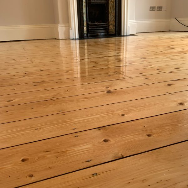 Restored hardwood floorboards in a home interior