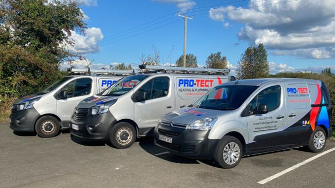 Three Pro-Tect Heating & Plumbing service vans parked together
