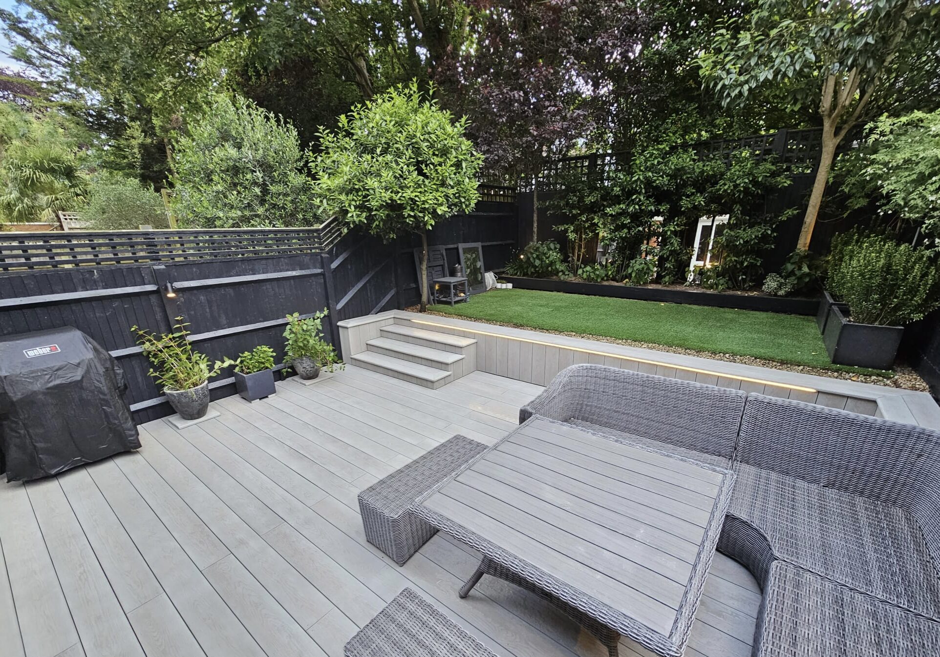 Finished composite deck patio with built-in seating and outdoor furniture