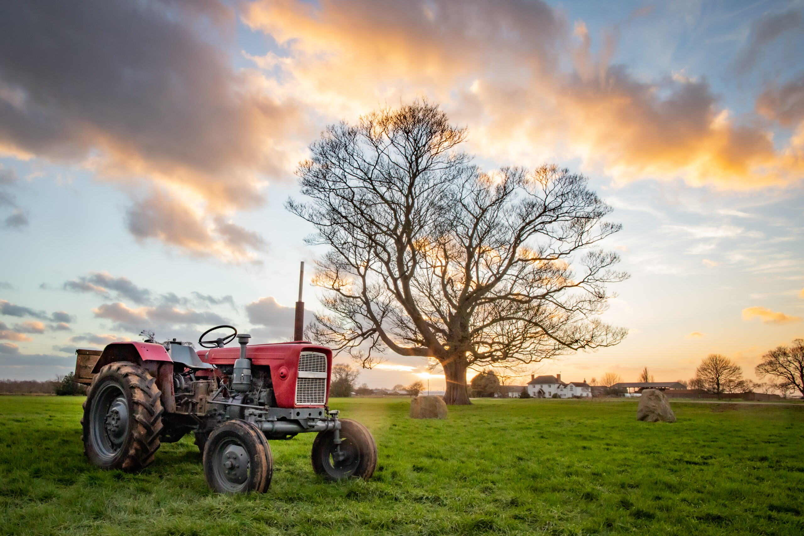 Tractor in a field at sunset / Tractor in a field at sunset