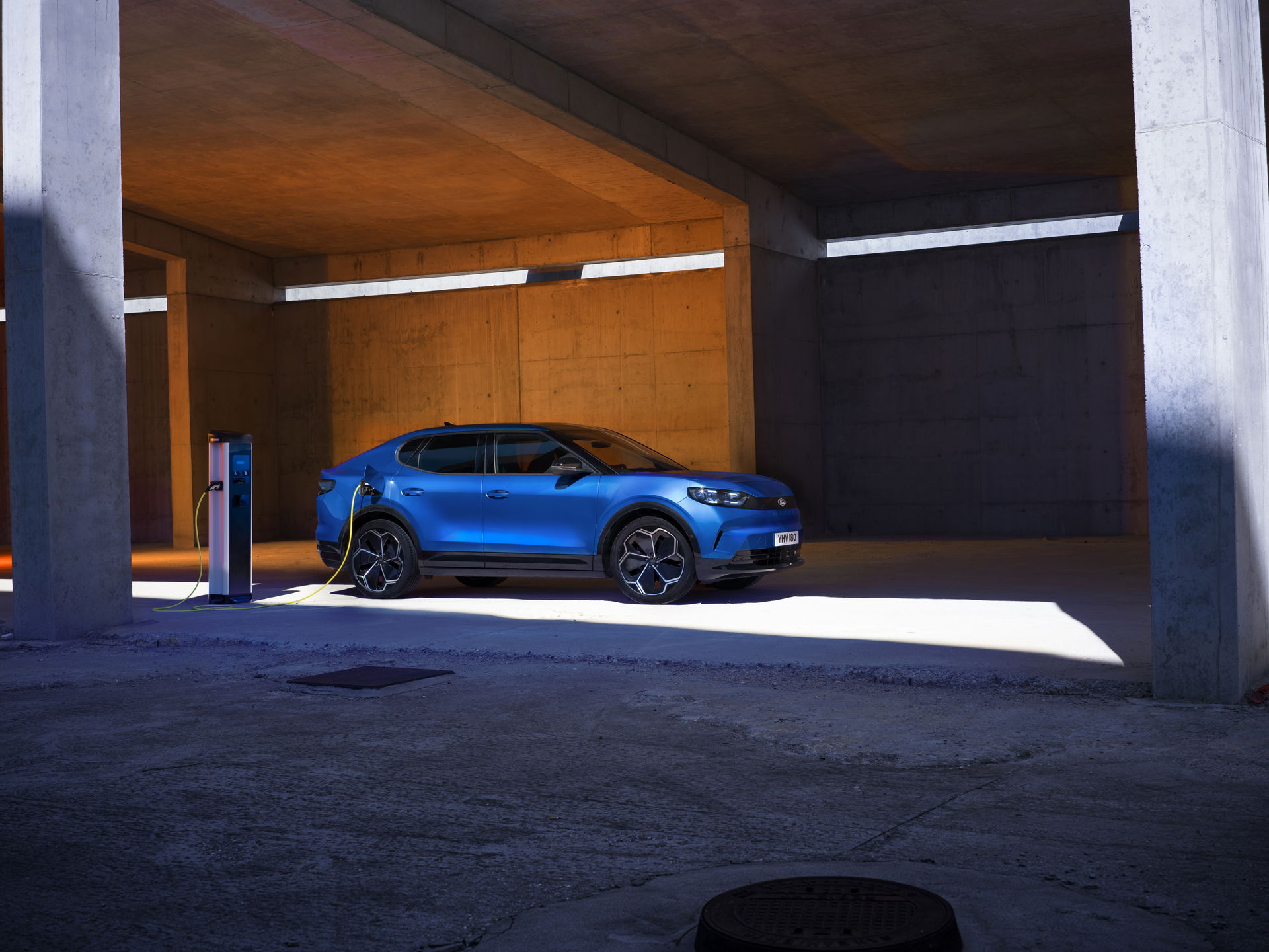 Blue passenger vehicle displayed in a modern indoor showroom