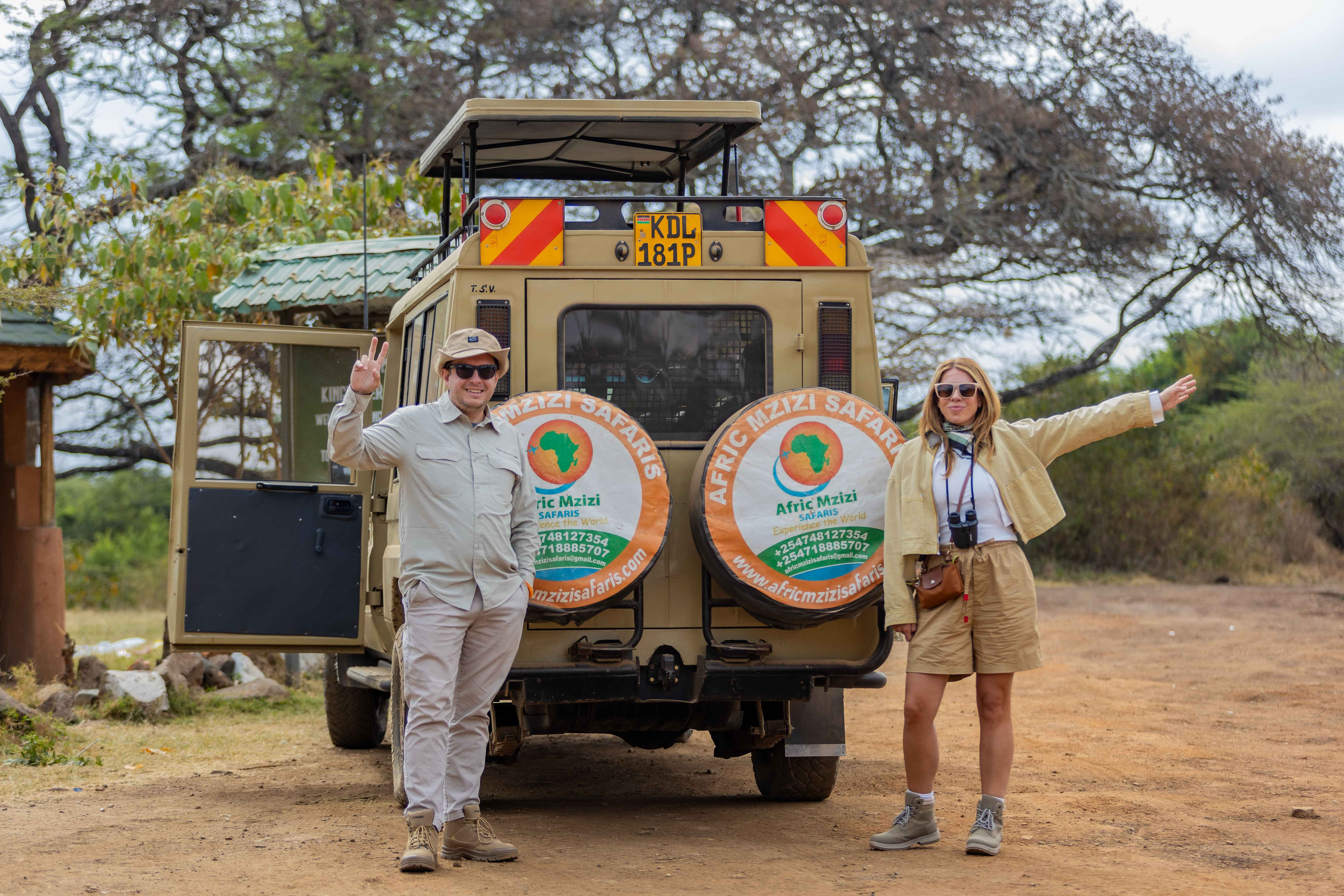 Travellers beside an Afric Mzizi Safaris vehicle in Kenya
