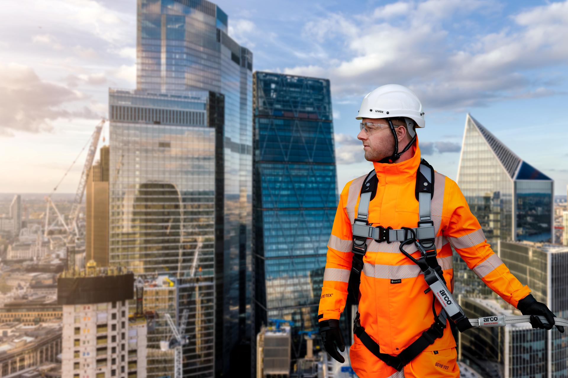 Worker wearing height-safety equipment and Arco branded gear