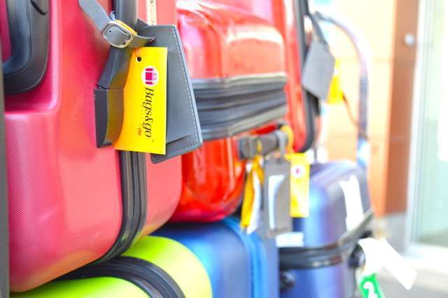 Travel bags beside an airport conveyor belt