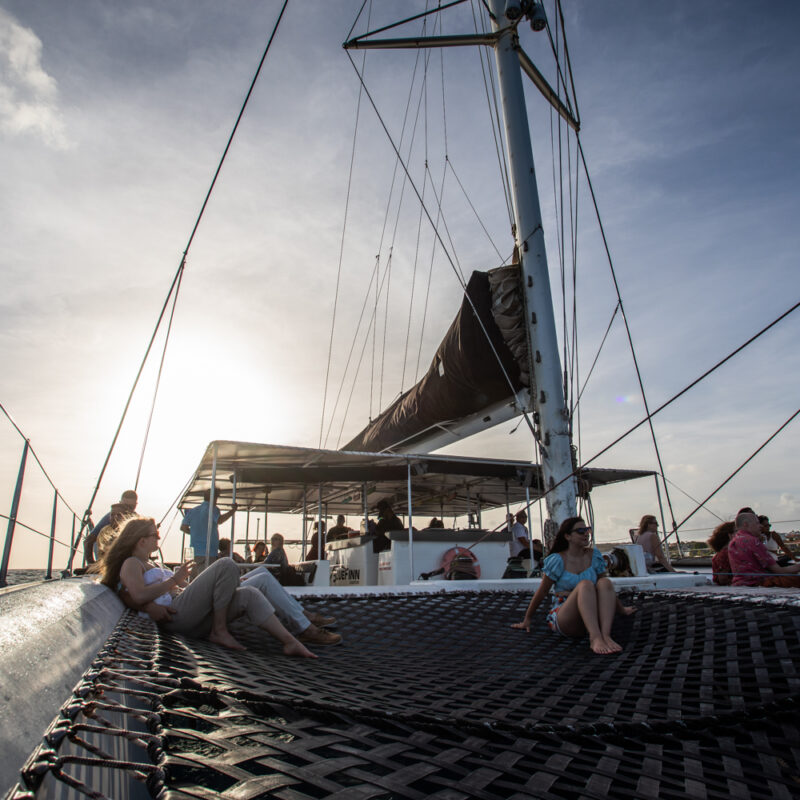 Guests aboard a sailing catamaran