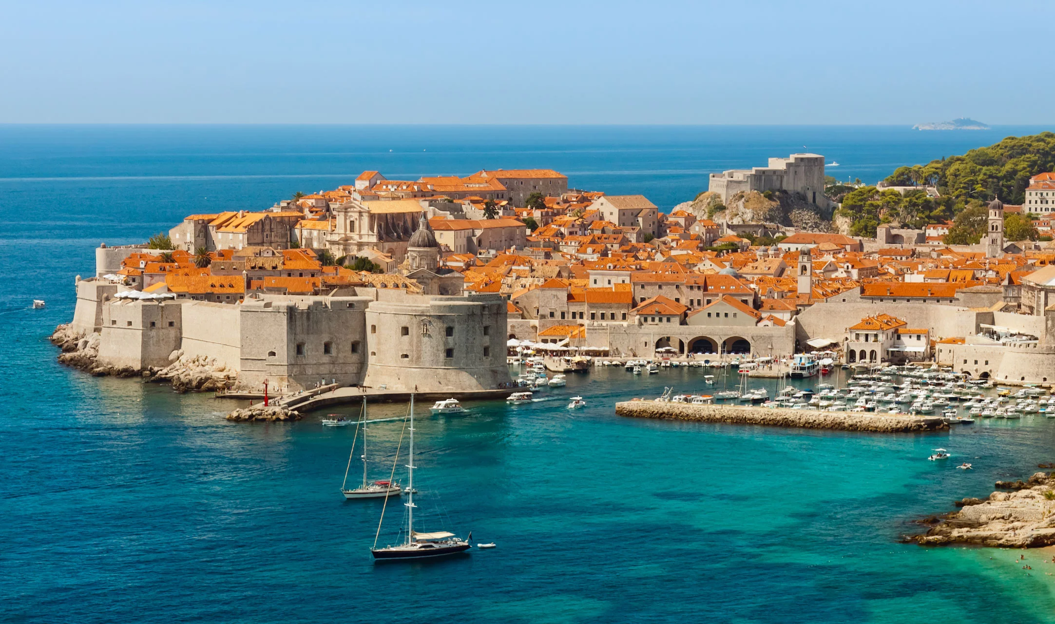 Small cruise boat in the Adriatic beside Dubrovnik’s historic harbour