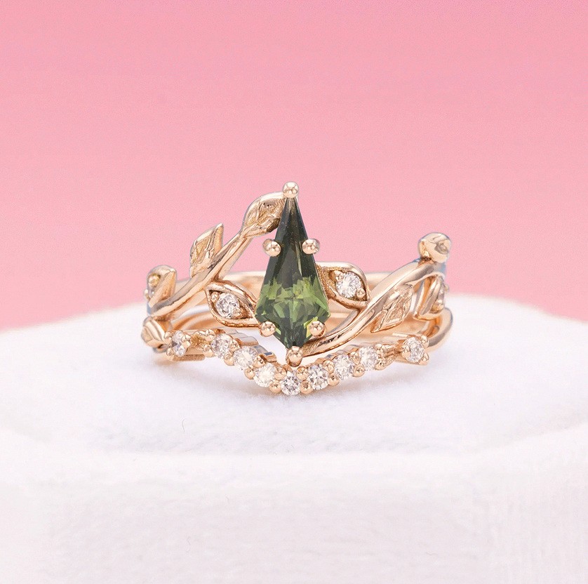 Custom engagement ring with green gemstone and diamond accents