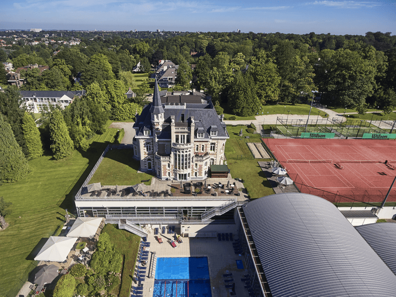 Aerial view of a David Lloyd club with tennis courts and a swimming pool