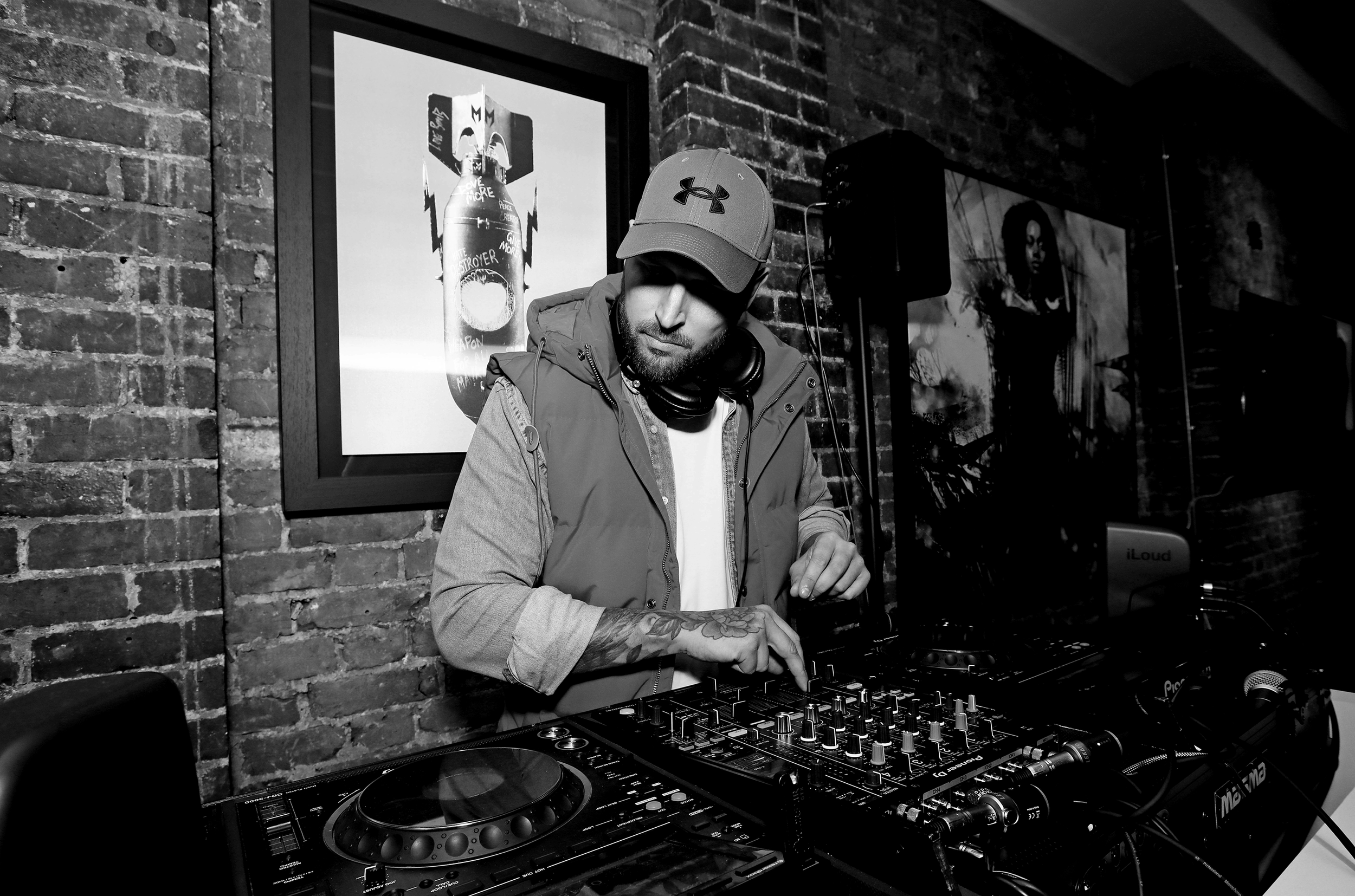 DJ performing with mixing equipment