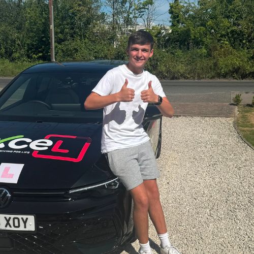 Learner beside an Excel Driving School tuition car