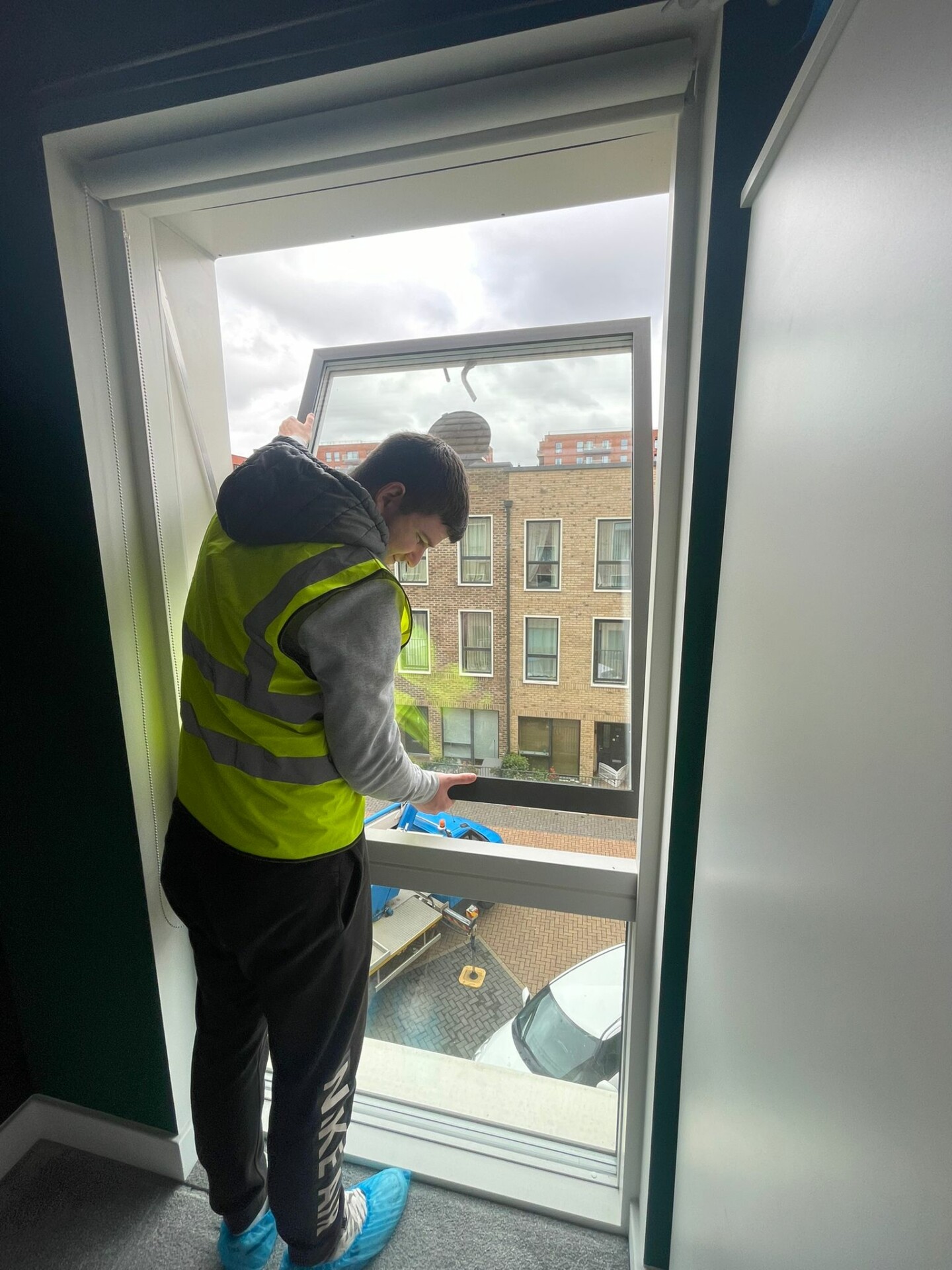 Installer fitting a glazed window shown by Ecostructive Glazing