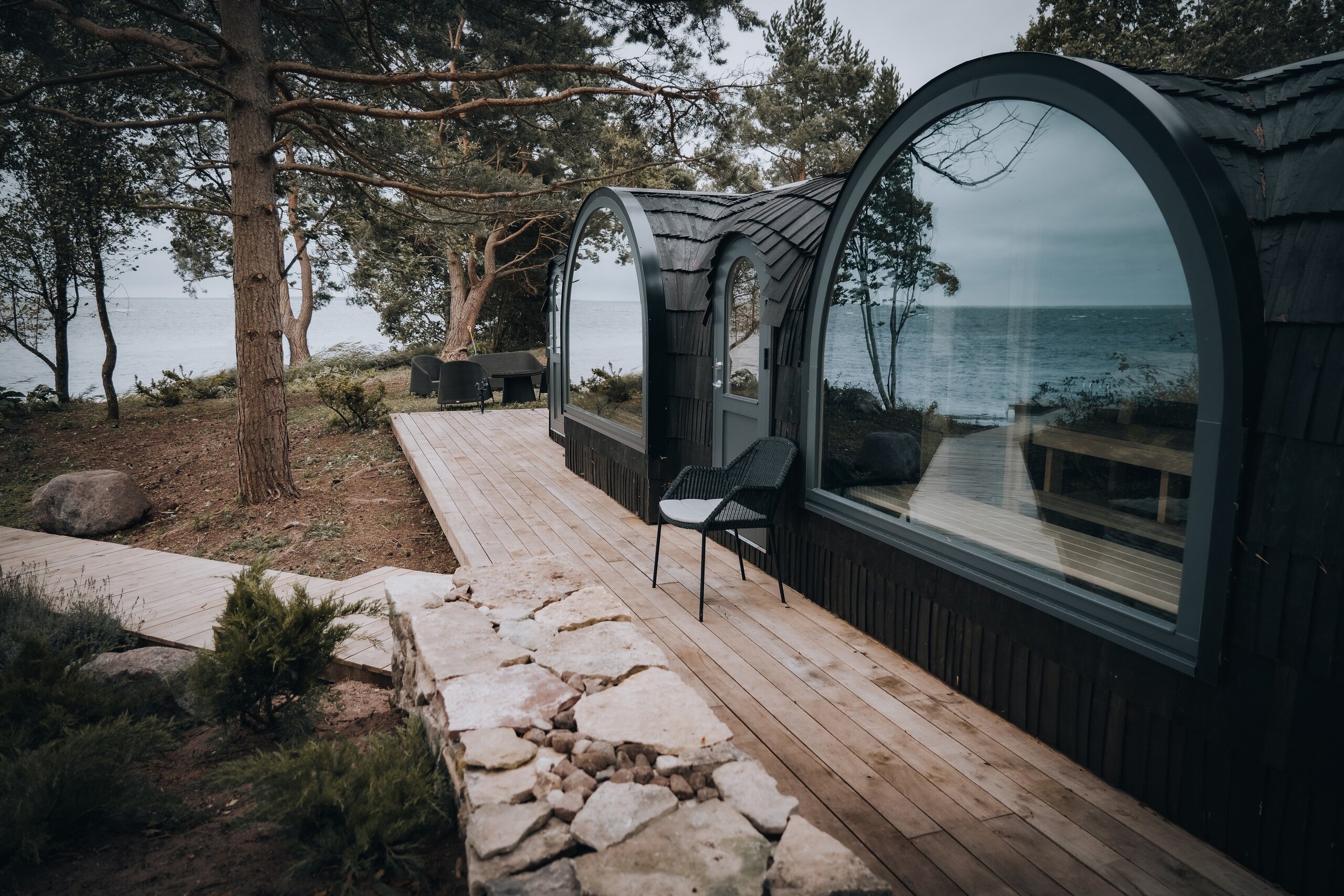 Rounded Iglucraft cabin with large window beside the water