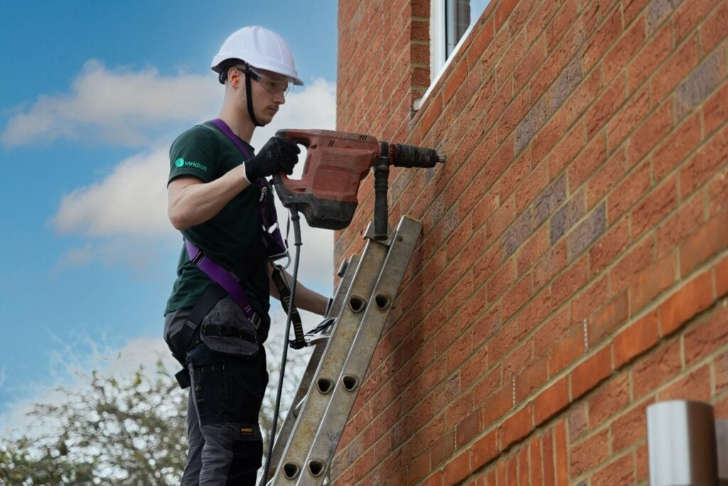 Viridian installer working on a brick cavity wall