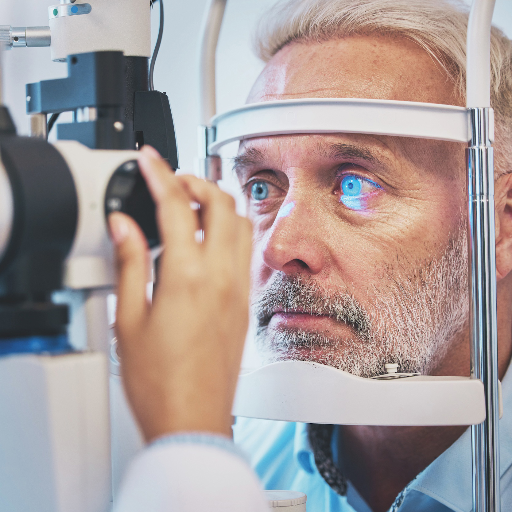 Optometrist examining a patient's eyes