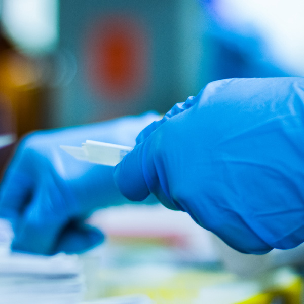 Laboratory worker handling a medical vial