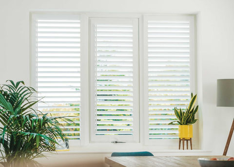 White made-to-measure window shutters in a living room
