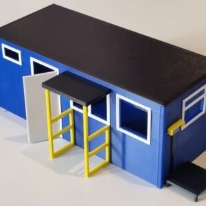 Small model railway building with blue walls and yellow details