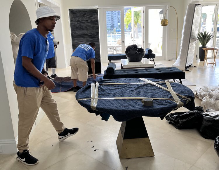 Movers preparing furniture for a move