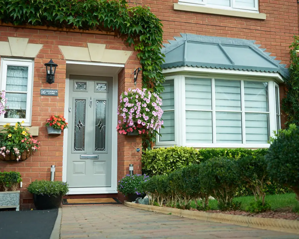 House entrance with glazed door and bay window