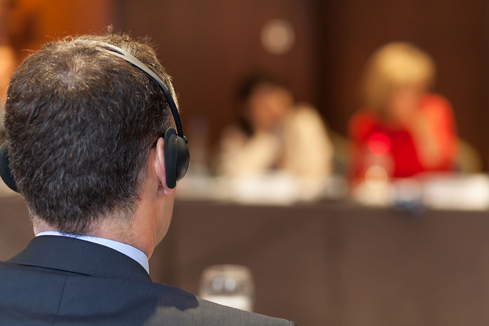 Interpreter wearing a headset during a meeting