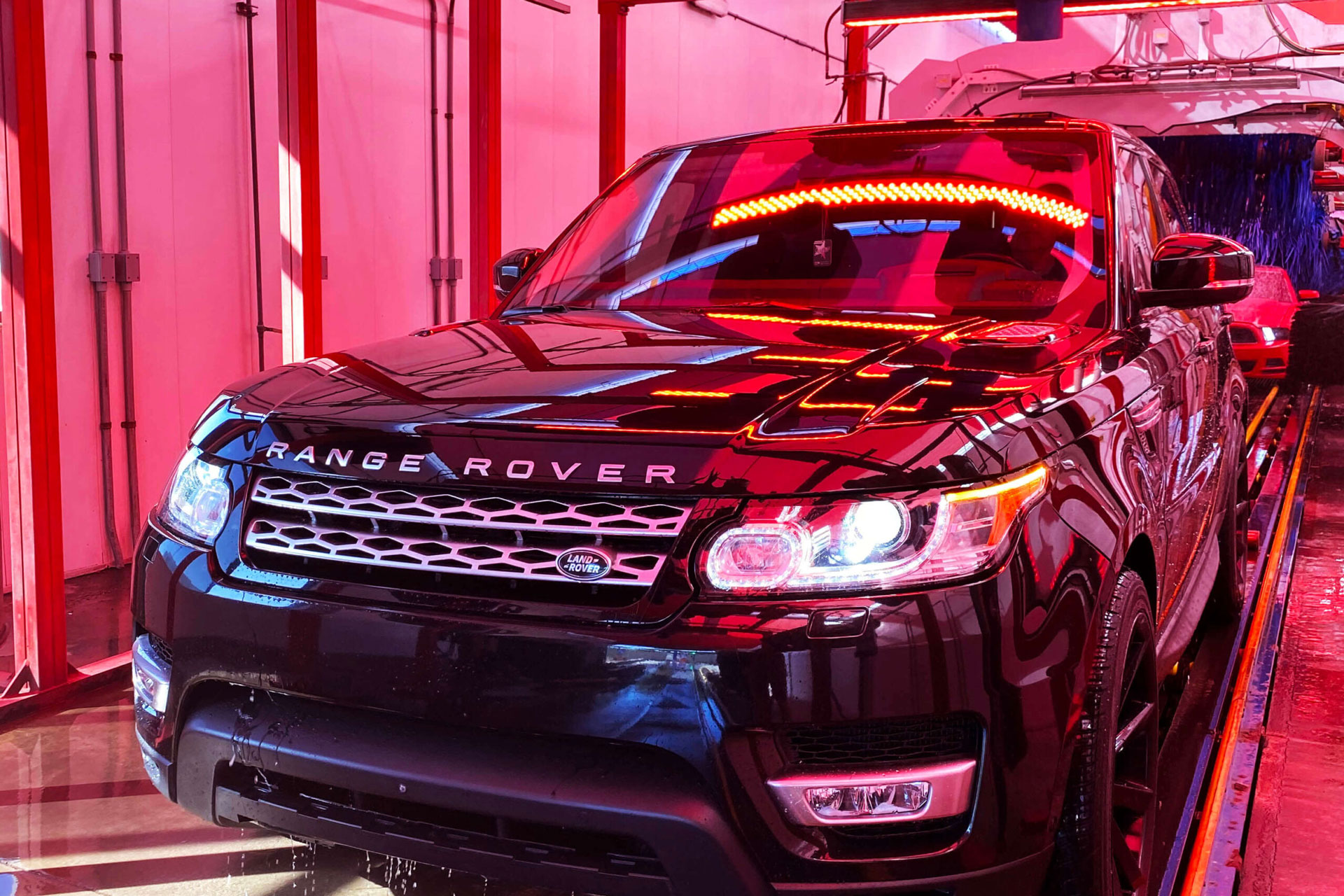 SUV passing through an automated car wash bay